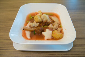 Noodles with seafood soup and red sauce called 