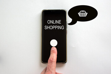 Male finger clicks on smartphone screen with a words 'online shopping' on the white background. Shopping cart sign. Concept.