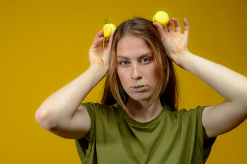 young european woman playes with fresh yellow macarons
