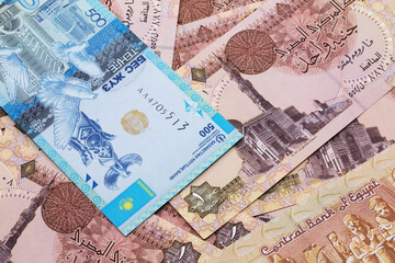 A blue five hundred tenge note from Kazakhstan with Egyptian one pound bank notes close up in macro