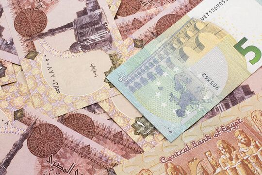 A close up image of a twenty shekel bank note from Israel on a background of Egyptian one pound bank notes in macro