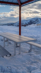 Vertical frame Small pavilion with a single picnic table with seats with Wasatch Mountain view