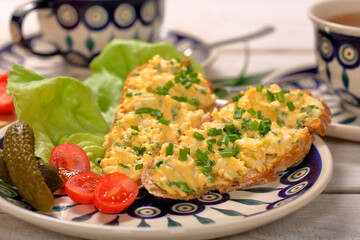 Sandwich with  scrambled eggs on the plate