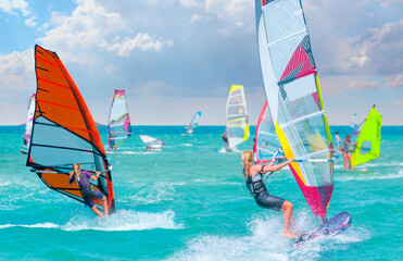 Beautiful cloudy sky with Windsurfer Surfing The Wind On Waves In Alacati - Cesme, Turkey 