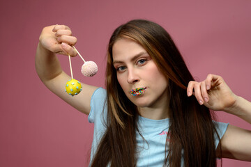 young european woman playes cake pops