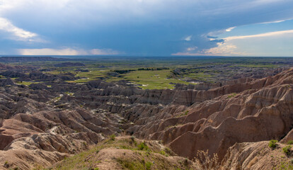 View of clouds over the canyons and country in the badlands of South Dakota. 
