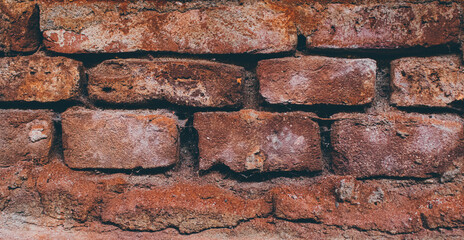 old degrading red brick wall