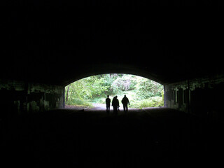 silhouette of a peoople walking in a tunnel