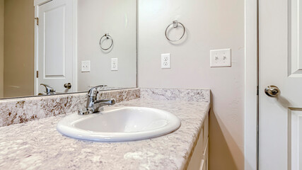 Panorama crop Top mount sink with stainless steel faucet on bathroom marble countertop
