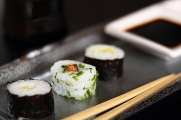 Sushi hosomaki and california maki on metal tray