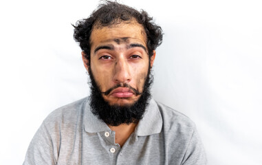 Arabic man with coal on his face having a bad day