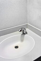 Modern white bathroom sink with faucet. Interior of bathroom with washbasin and faucet.