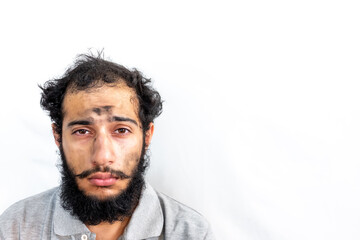 Arabic with coal dust on his face looking pale