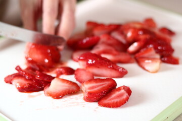 Slicing strawberry. Making frozen strawberry cheesecake series.