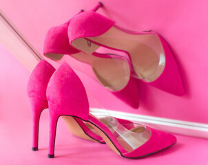 stylish pink high heels shoes on pink background watching its own reflection in the mirror. Shoes, fashion, ego, selfish, narcissism, style, shopping, sale concept