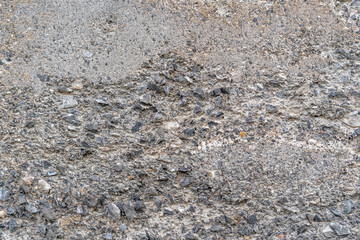 Old concrete destroyed wall with bumps and cracks