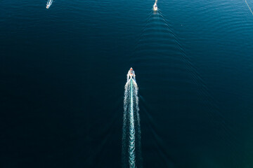 Top down view of a boat cruising on blue water
