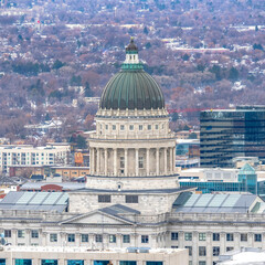 Square The Utah State Capital Building against downtown Salt Lake City during winter