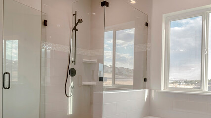 Panorama Built in bathtub with black faucet and shower stall with half glass enclosure