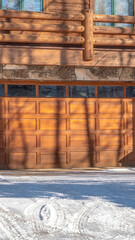 Vertical crop Facade of a luxury wooden home in Park City Utah with snowy driveway in winter