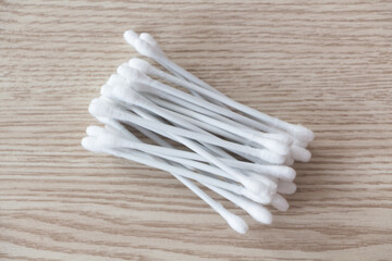Heap of cotton buds on wooden background