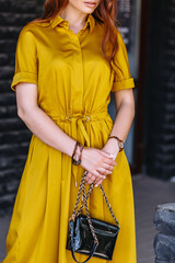Model in a light yellow dress on the street