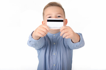 blonde caucasian cute boy in blue shirt holding credit card.picture isolated on white background.