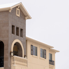 Square Beautiful apartments with arched balcony stone wall and snowy roof in winter