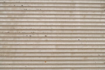 Old metal louvres with peeling paint and rust