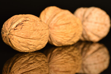 Ripe tasty, organic walnut, close-up, on a black background.