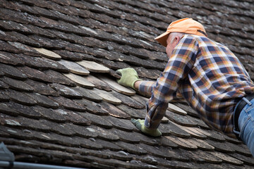 Man repairing old roof