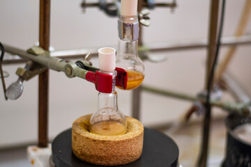 Round bottom flask with yellow liquid for for advance chemical synthesis in a chemistry laboratory...