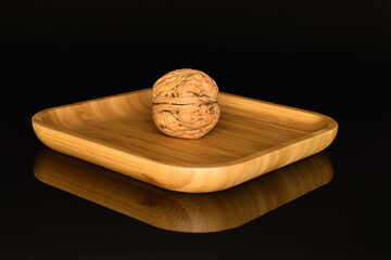 Ripe tasty, organic walnut, close-up, on a black background.