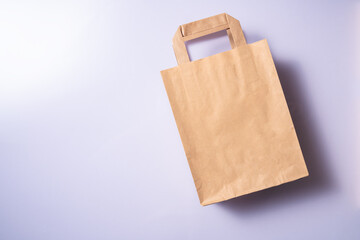 Shopping paper bag. Concept of consumerism, shopping symbol. Copy space trend pastel color.