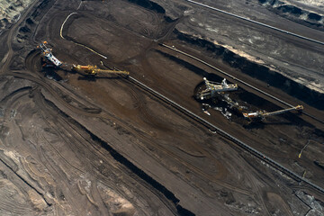 Aerial shoot of quarry with heavy bucket wheel excavators mining a coal. Heavy industry concept.