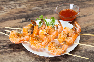 Grilled prawn skewer with sauce