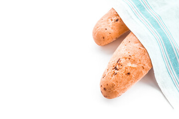 two French baguettes covered with a linen towel.The concept of making bread at home