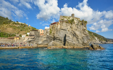 Fototapeta na wymiar The Castello Doria, the ancient fort along the Ligurian Coast is visible from the sea at the fishing village of Vernazza, Italy, part of the Cinque Terre.