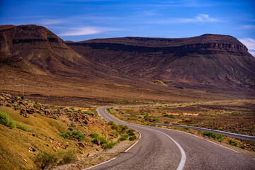 An empty road running thorugh east of Morocco. 