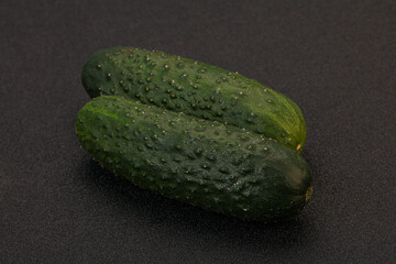 Green fresh cucumbers over background