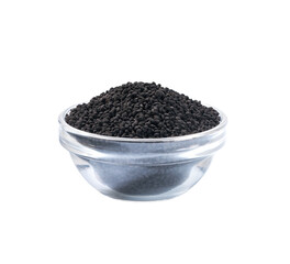 black caraway in a small transparent glass bowl isolated on a white background.