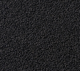 Fototapeta premium black caraway seeds as texture background, top view.