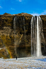 Photo of an icelandic waterfall in Iceland with a rainbow