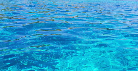 The sea is bright blue and turquoise. Close-up image.