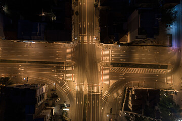 Top down view of an empty city intersection during curfew at night 