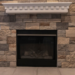 Square Fire insert in a feature stone brick wall