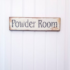 Square White panelled door with rustic rectangular wooden Powder Room sign
