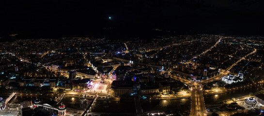 Large aerial panoramic shot of Skopje, North Macedonia at night. Night panorama of the city center of Skopje - obrazy, fototapety, plakaty