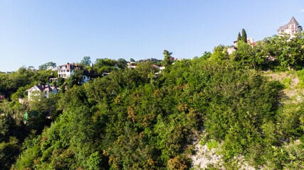 The expanse of the sea meets the sandy beach. Soft sea waves of blue transparent water on the beach. A soft wave of blue tropical beach serenity, a natural backdrop for summer holidays. Aerial view fr