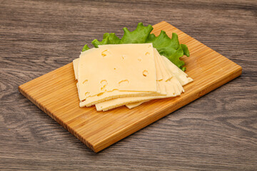 Sliced yellow cheese over board